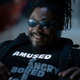 Marshawn Lynch in a scene from Westworld, wearing a t-shirt that changes highlighted words based on his mood.